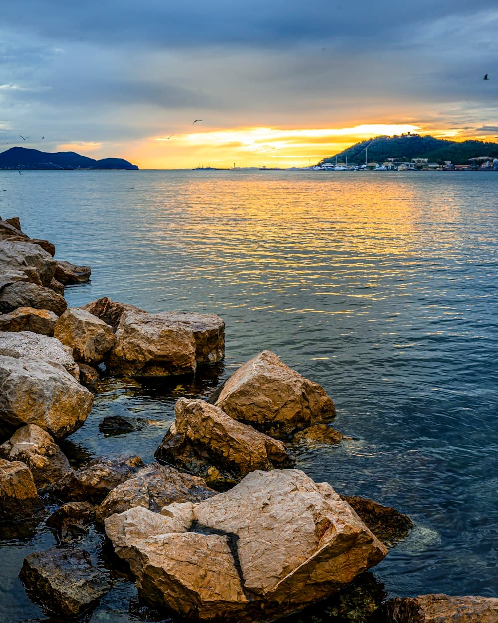 A calm Mediterranean coastline at sunrise, representing hope and recovery